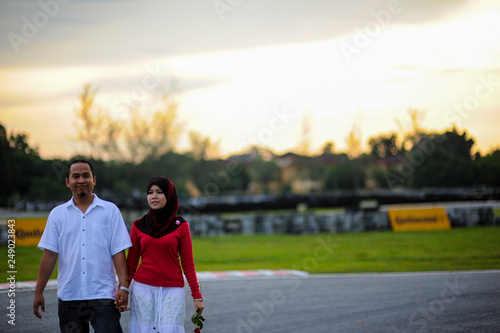 Potrait of happy young couple enjoying a day in park together. © Mhilmi Osman