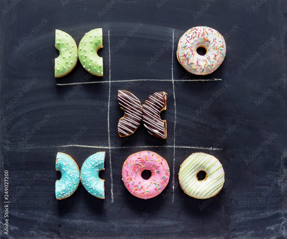 Tic tac toe made of donuts. Game noughts and crosses with donuts on ...