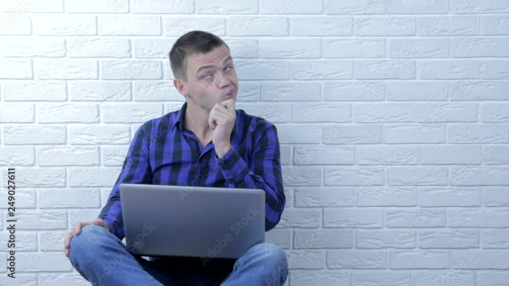 Confused young man pondering all the choices before making a decision Confused young man pondering all the choices before making a decision