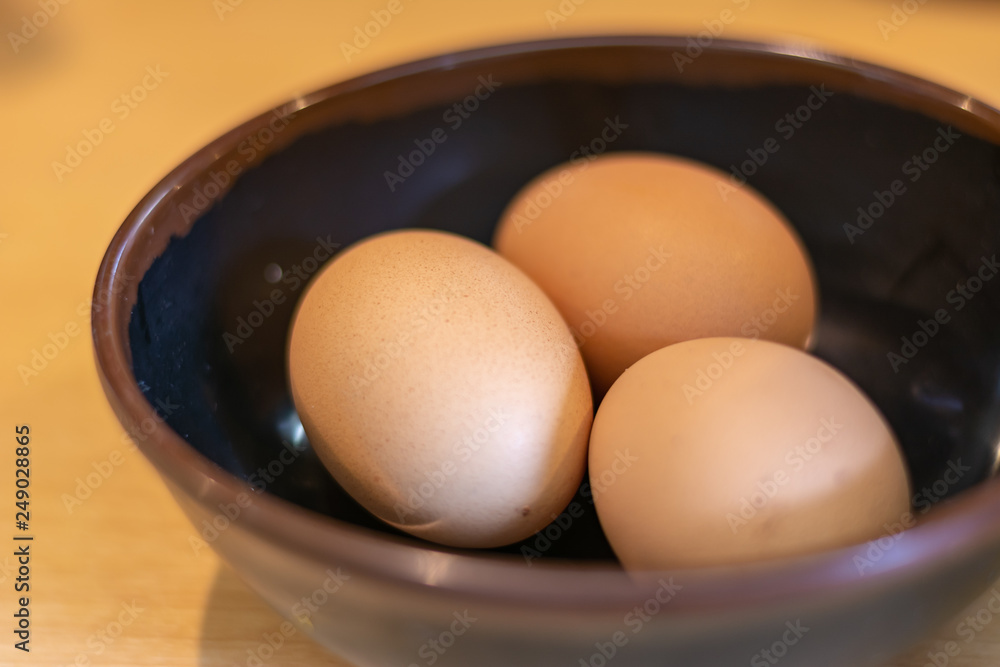 Eggs in bowl on wooden background, thin focus. Eggs in bowl on wooden background, thin focus.