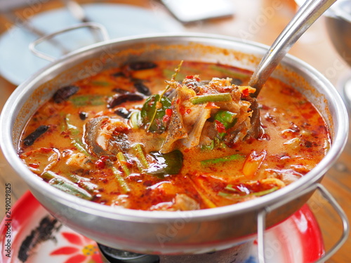 Hot and spicy fish soup, Thai famous food called Tom Yum serving in hot pot selling in the Thai restaurant