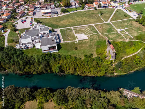 Drone view to the destroyed railway bridge in river Neretva and historical museum in city of Jablanica © MuamerO