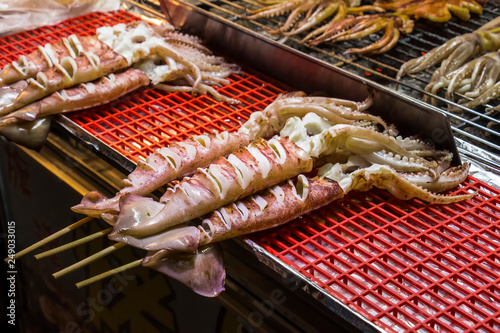 Fresh whole squid on stick ready for barbeque