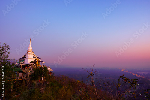 The pagoda of the Thai temple on the top of the mountain during dawn.Thai temple name Wat Phra Phutthabat Pha Nam at Li city Lamphun Thailand