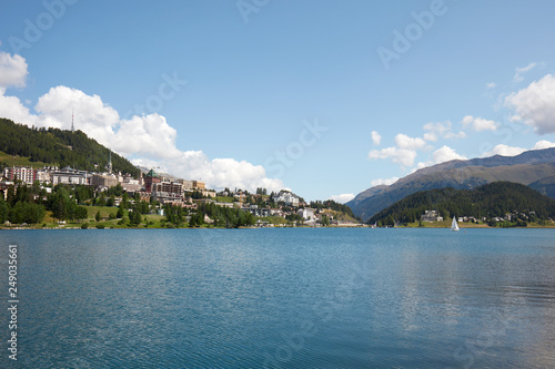Sankt Moritz town and lake with boat in a sunny summer day in Switzerland