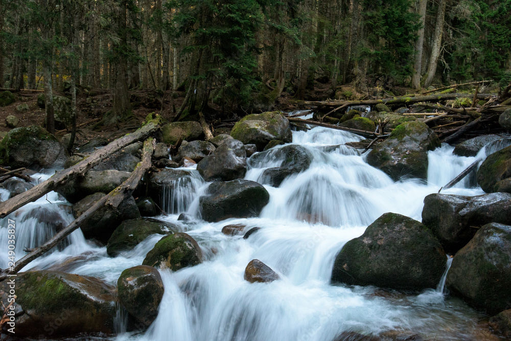 river in the mountains. mountainous area. photo on a long exposure, cloudy day.  waterfalls in the mountains in the forest