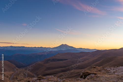 sunset in the mountains on the background of mount Elbrus. pink sky.