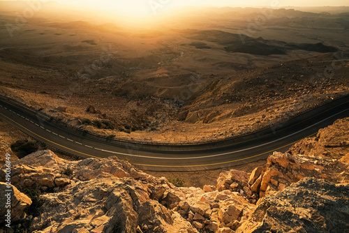 Road under the rock of the huge crater Mitzpe Ramon in the desert of Israel photo