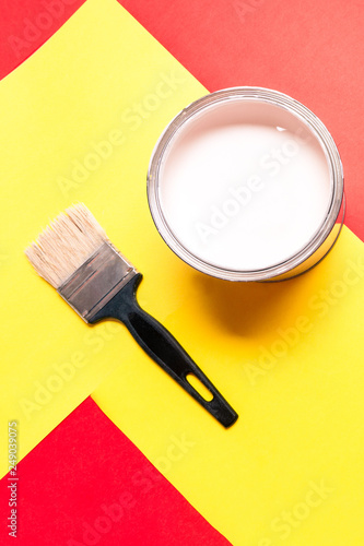 White Paint Can with Brush Top View On Yellow Background.