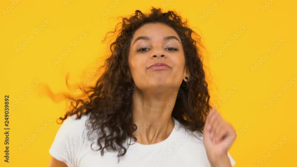 Happy girl dancing to rhythm, enjoying favorite melody, energetic and carefree Happy girl dancing to rhythm, enjoying favorite melody, energetic and carefree