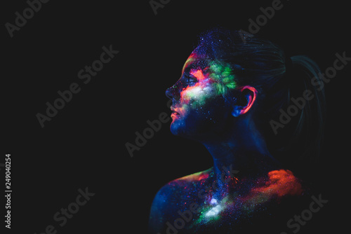 Portrait of a girl painted in fluorescent UV colors. photo