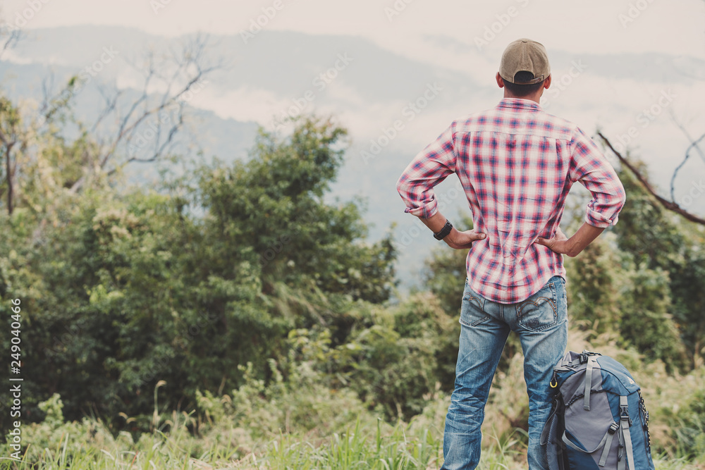 Hiking man traveling with backpack in mountains