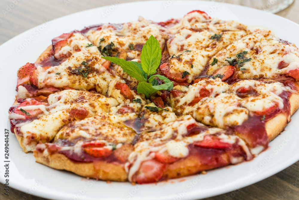 Strawberry pizza on a white plate