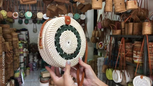 Woman holding rattan eco bags in the art shop on Bali island, Indonesia. Woman stylish eco bag.