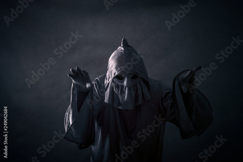 Scary figure in hooded cloak  photo