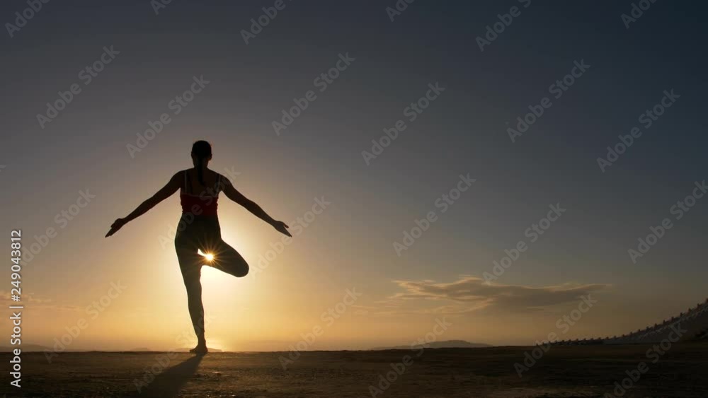 Woman silhouette doing yoga fitness exersice at sea beach in sunrise. Woman silhouette doing yoga fitness exersice at sea beach in sunrise.