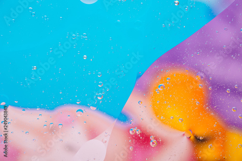 Water oil bubble macro abstract background flow liquid blue aqua yellow pink red colors