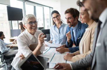 Group of young business people working and communicating at the office