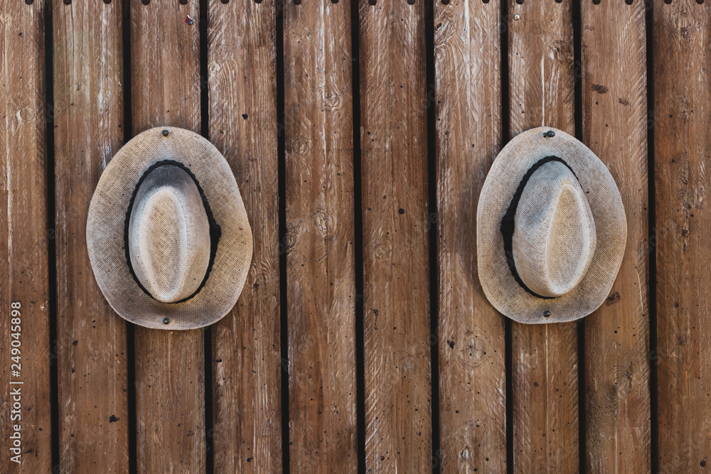 summer hat hanging from wooden wall summer hat hanging from wooden wall