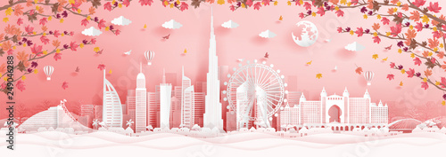 Autumn in Dubai with falling maple leaves and world famous landmarks in paper cut style vector illustration