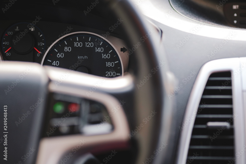 Many extra, modern car interior, close-up of dashboard, speedometer.