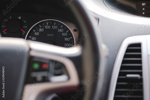 Many extra, modern car interior, close-up of dashboard, speedometer.