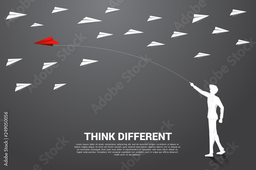 silhouette of businessman throw out red origami paper airplane opposite with others white. Business Concept of think different and entrepreneur