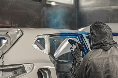 Employee car body painting shop carries out painting of the internal elements of the car © vadimalekcandr