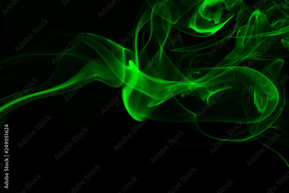 Obraz premium Green smoke abstract on black background, darkness concept