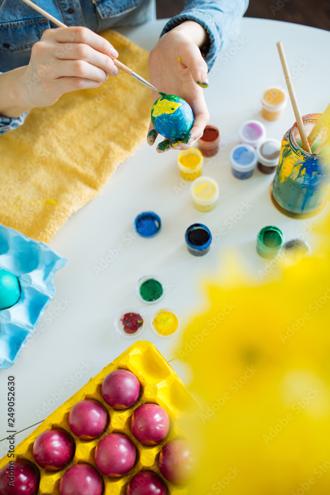 Girl paints eggs