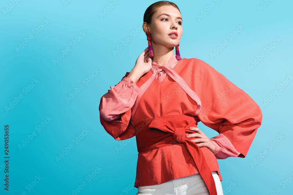 attractive fashionable girl posing in trendy living coral clothing isolated on blue attractive fashionable girl posing in trendy living coral clothing isolated on blue