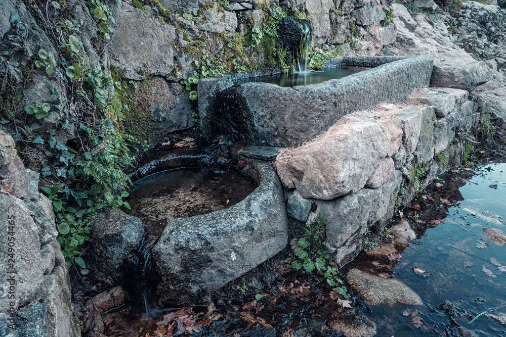 Ancient stone water troughs on trail in Corsica Ancient stone water troughs on trail in Corsica