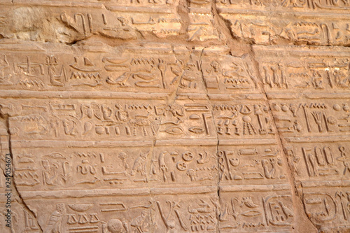 Egyptian hieroglyphs, symbols and signs on a stone wall in Karnak temple. Bass-relief.