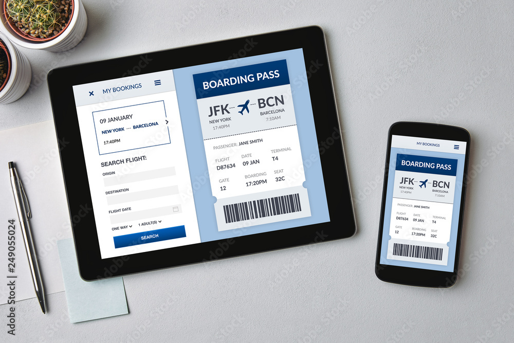 Boarding pass concept on tablet and smartphone screen Boarding pass concept on tablet and smartphone screen