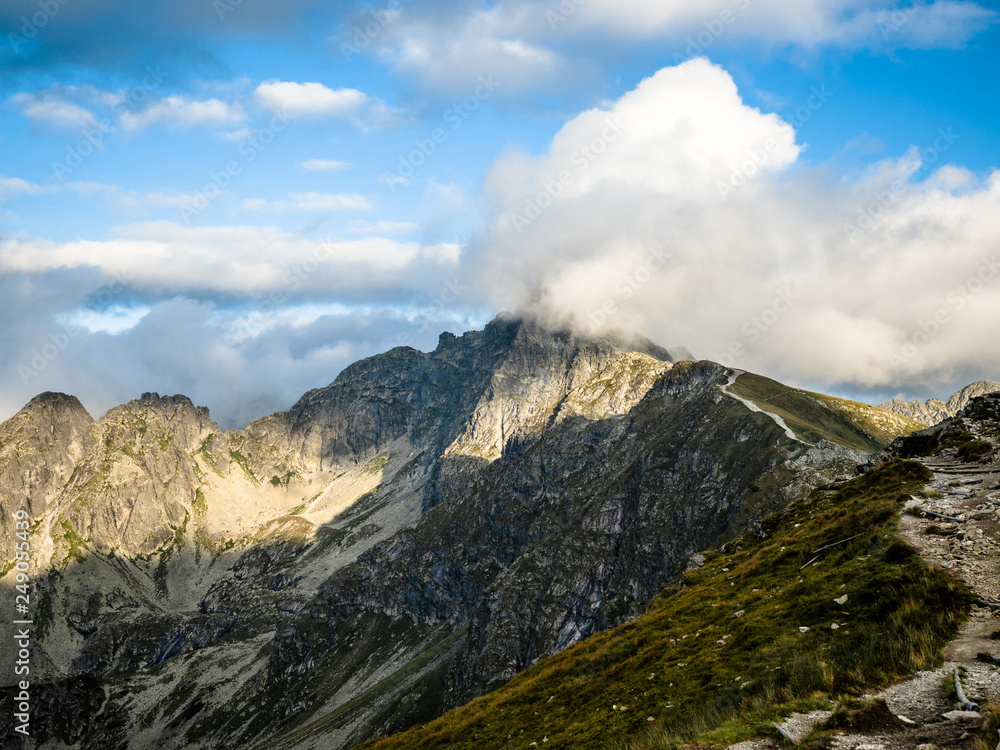 Tatra Mountain part of Carpathian mountain chain in eastern Europe create natural border between Slovakia, Poland. Both protected as national parkland popular destination for winter, summer sports. 