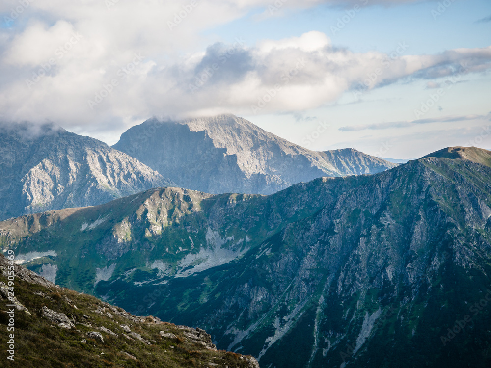 Tatra Mountain part of Carpathian mountain chain in eastern Europe create natural border between Slovakia, Poland. Both protected as national parkland popular destination for winter, summer sports. 