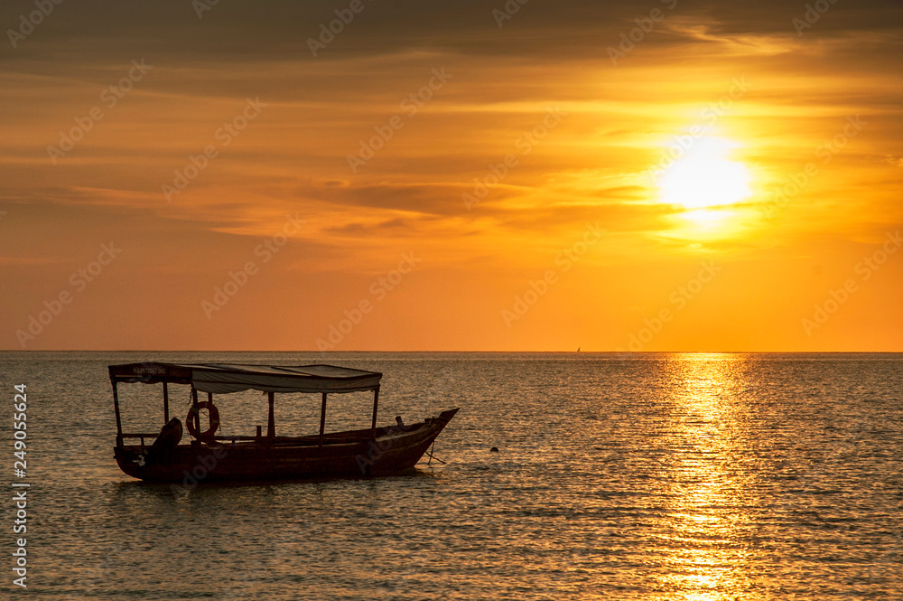 Traditional dhow boat at sunset, Zanzibar, Tanzania.