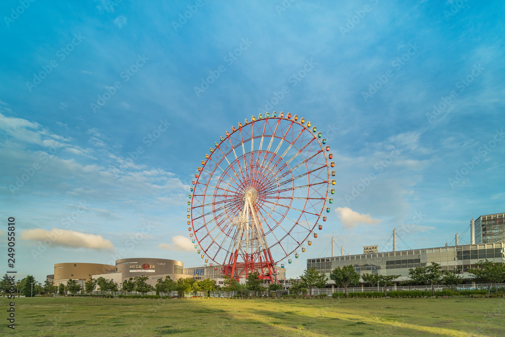 Odaiba colorful tall Palette Town Ferris wheel named Daikanransha visible from the central urban area of Tokyo in the summer blue sky. Passengers can see the Tokyo Tower. Odaiba colorful tall Palette Town Ferris wheel named Daikanransha visible from the central urban area of Tokyo in the summer blue sky. Passengers can see the Tokyo Tower.