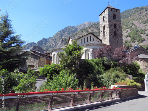 Beautiful medieval building with a tower  on the background of the Pyrenees mountains,  view in good summer weather, Andorra, Europe.