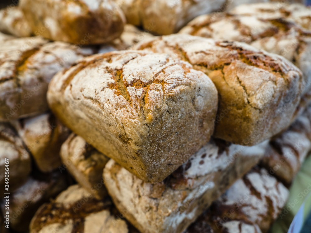 Homemade bread loaves. Fresh bread in bakery background and texture for banner image on website or print media design. Rye bread on market stall. 