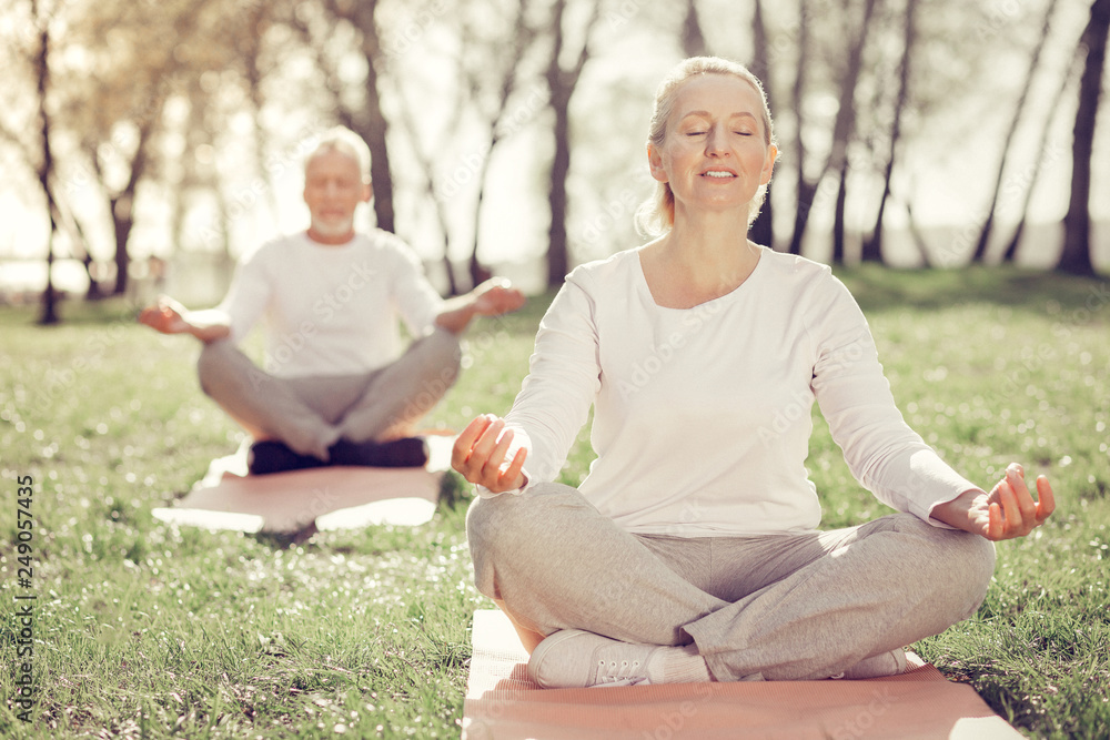 Relaxed blonde female enjoying her yoga practice Relaxed blonde female enjoying her yoga practice
