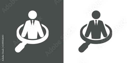 Icono plano hombre de negocios dentro de lupa en gris y blanco
