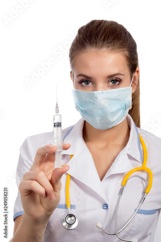 Young  female doctor in a mask   with syringe