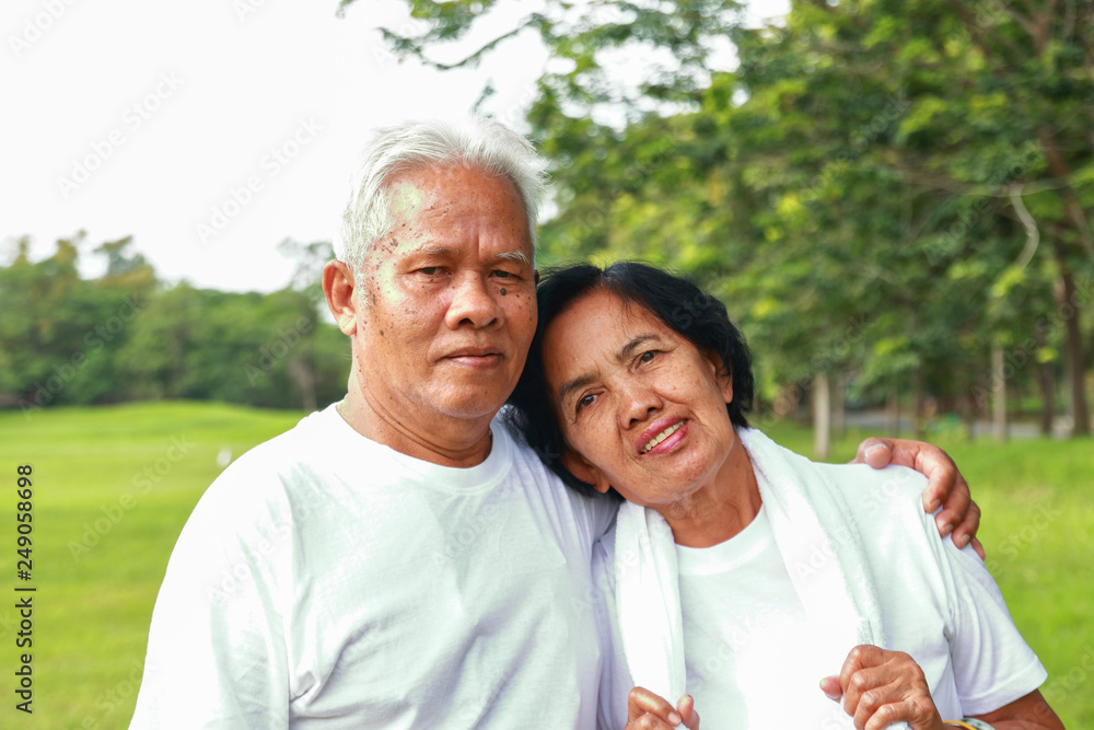Older Asian couples exercise in the park. Older Asian couples exercise in the park.