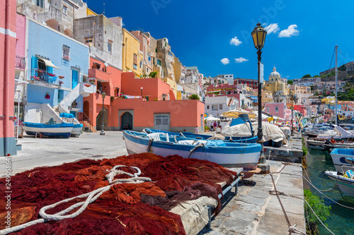 Pretty fishing village, colourful fishermen's houses, and fishing nets, Marina Corricella Procida Island, Bay of Naples, Italy. photo