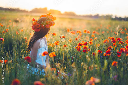 Woman at a flower field in summer sunset