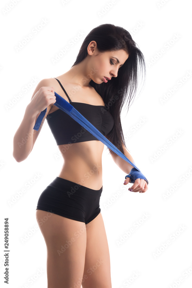 Beautiful sexy young woman putting boxing bandage on her hands Beautiful sexy young woman putting boxing bandage on her hands