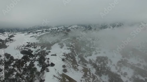 Epic landscape. In the mountains of Kazakhstan, Almaty. Mountains in the fog. Aerial view.