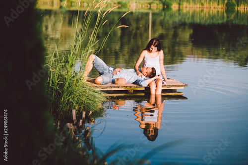 young love couple at the lake in summer sunset