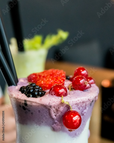 berry and yoghurt smoothie and green detox smoothie in a cozy cafe